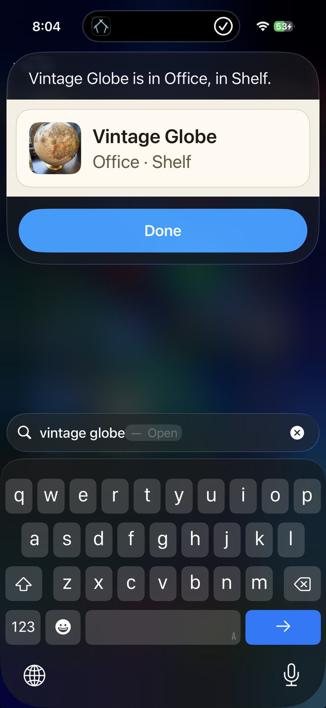 An item name typed into iPhone search, with the answer card above it reading “Vintage Globe is in Office, in Shelf.”